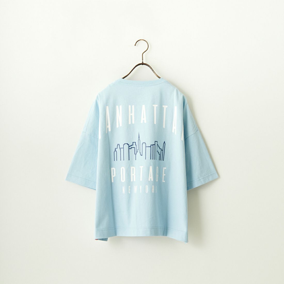 MANHATTAN PORTAGE [マンハッタンポーテージ] 別注 バックアーチロゴプリントTシャツ [24SSMP-INL012-JF]SAX