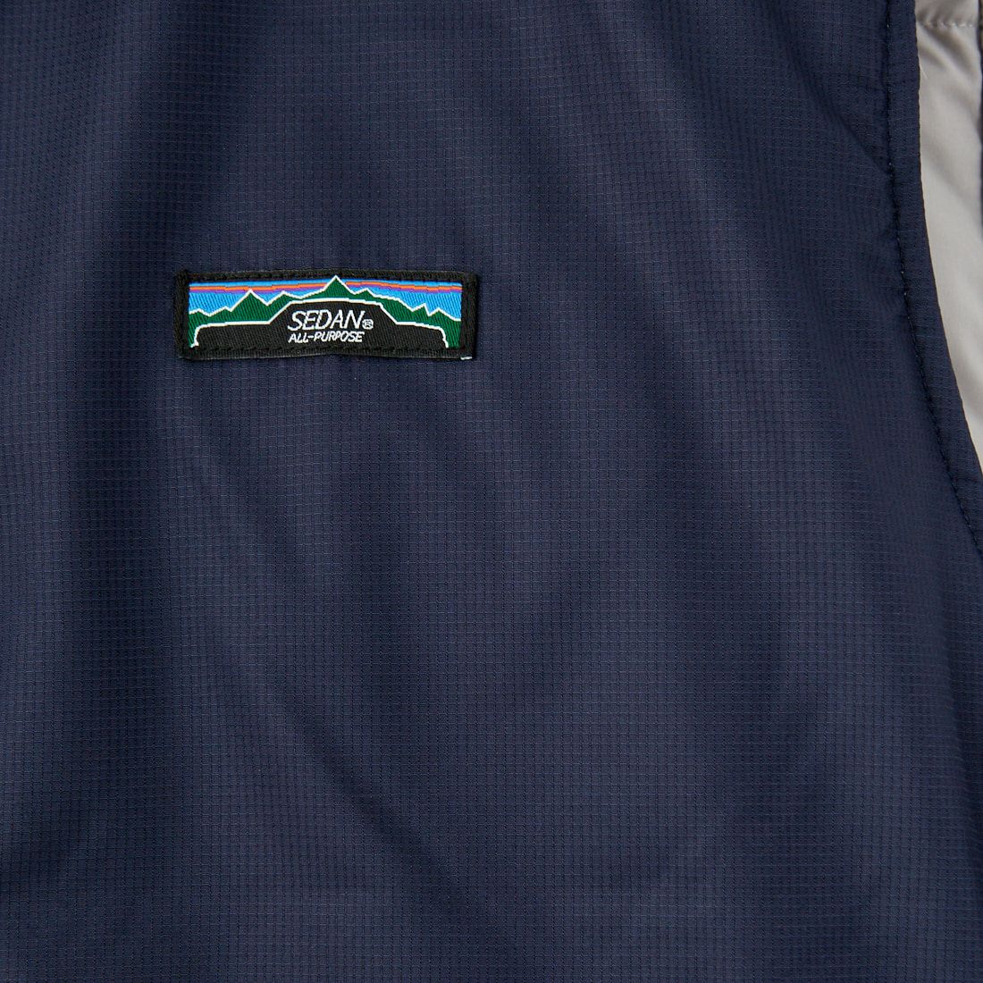 SEDAN ALL-PURPOSE [セダン オールパーパス] リバーシブルダウンベスト [SD24F-JK02] STONE/NVY
