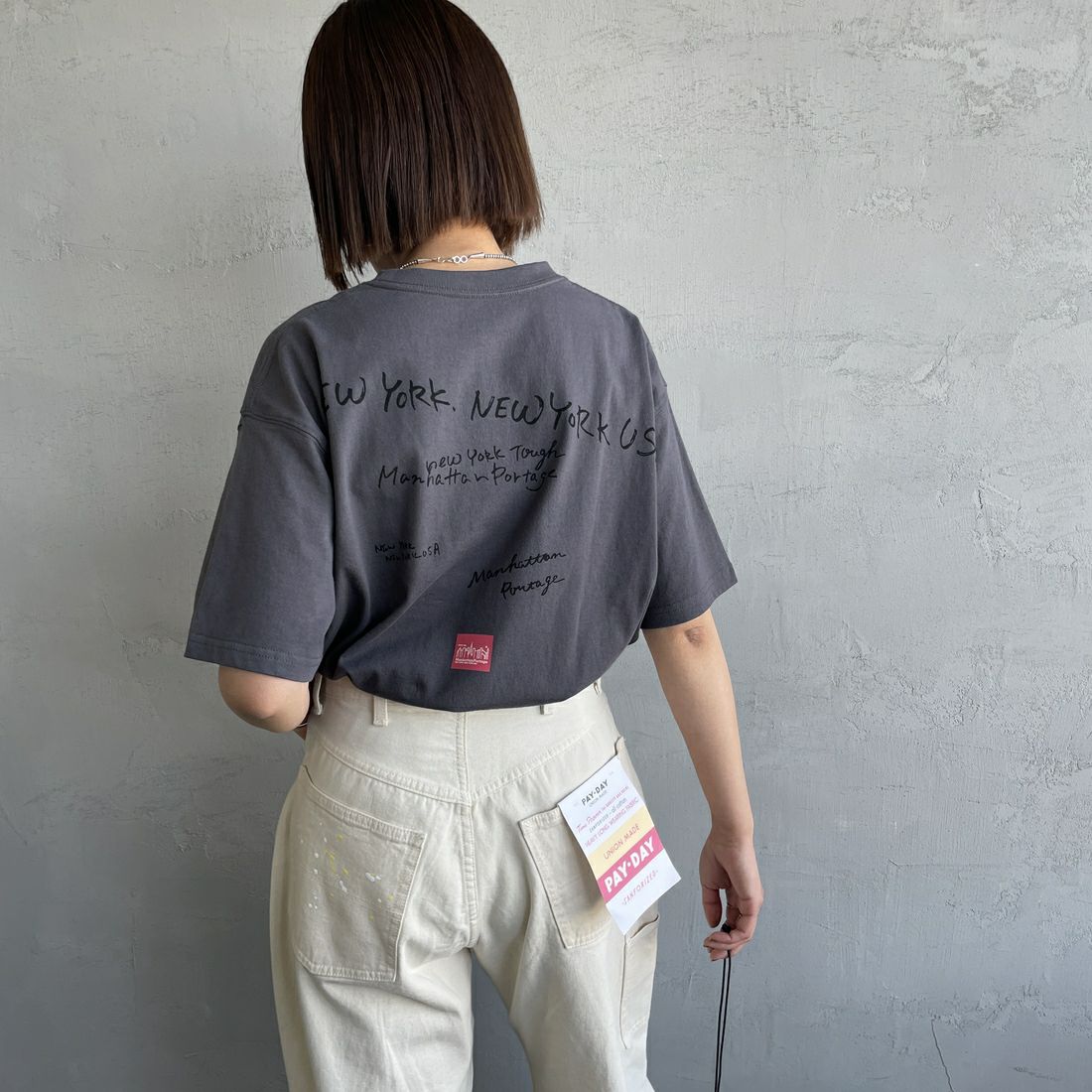 MANHATTAN PORTAGE [マンハッタンポーテージ] 別注 ランダムロゴ バックプリントTシャツ [25SSMP-IN66-JF] CHARCOAL &&モデル身長：159cm 着用サイズ：S&&