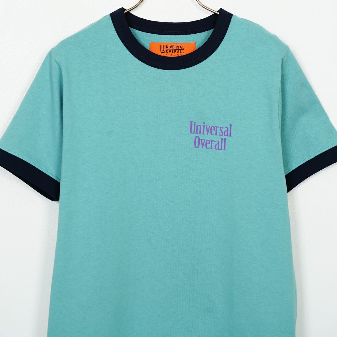 UNIVERSAL OVERALL [ユニバーサルオーバーオール] 別注 ロゴプリント リンガーTシャツ [U2513209IN-JF] T.BLUE/NVY
