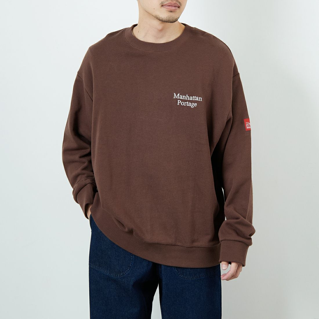 MANHATTAN PORTAGE [マンハッタンポーテージ] 別注 手書き風バック刺繍クルーネックスウェット [25FWMP-IN69-JF] D.BROWN &&モデル身長：168cm 着用サイズ：L&&
