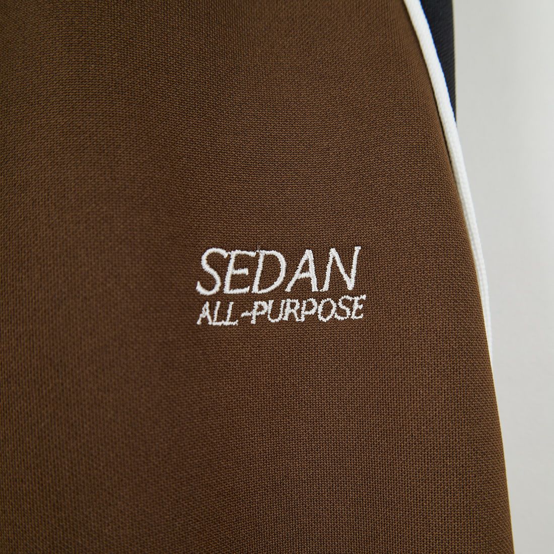 SEDAN ALL-PURPOSE [セダン オールパーパス] OGロゴ トラックパンツ [SD25F-PT05] BRN/BLK