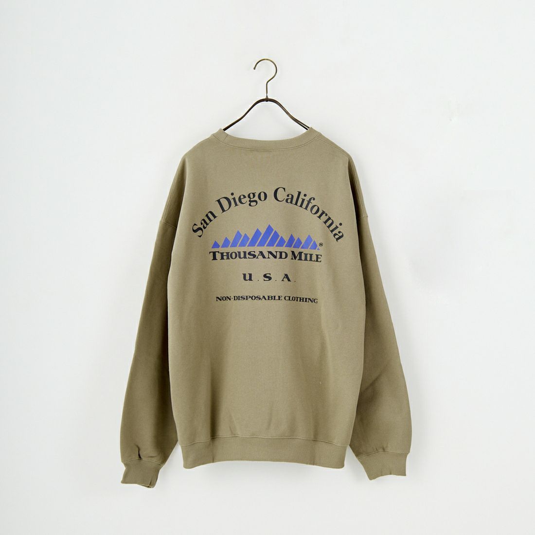 THOUSAND MILE [サウザンド マイル] 別注 バックプリント クルーネックスウェット [TM252UK50520-JF] 23 BEIGE